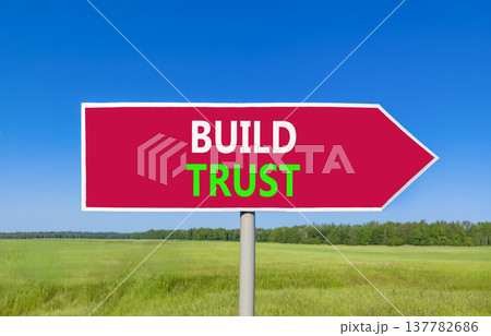 Build trust symbol. Concept words Build trust on beautiful red road sign. Beautiful blue sky green grass field background. Business and build trust concept, copy space. Build trust symbol. Concept words Build trust on beautiful red road sign. Beautiful blue sky green grass field background. Business and build trust concept, copy space. 137782686