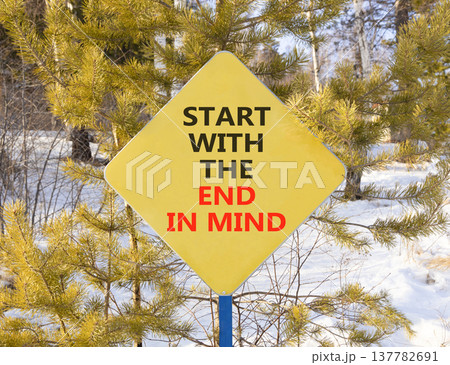 Start with the end in mind symbol. Concept words Start with the end in mind on beautiful yellow road sign. Beautiful winter forest background. Business start with the end in mind concept. Copy space. 137782691