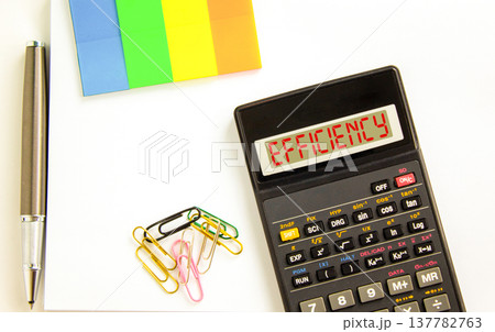 Efficiency symbol. Concept word Efficiency on beautiful black calculator's screen. Beautiful white background. Colored paper and black pen. Business efficiency concept. Copy space. Efficiency symbol. Concept word Efficiency on beautiful black calculator's screen. Beautiful white background. Colored paper and black pen. Business efficiency concept. Copy space. 137782763