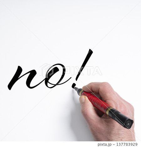 a hand writing the word NO with a marker 137783929