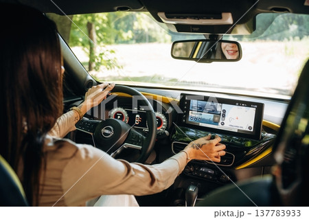 Interior of modern car. Young woman is sitting in it Interior of modern car. Young woman is sitting in it 137783933