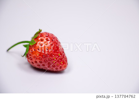 Fresh ripe red strawberry with green leaf isolated on white background. Organic sweet berry with detailed texture, studio lighting and copy space. Fresh ripe red strawberry with green leaf isolated on white background. Organic sweet berry with detailed texture, studio lighting and copy space. 137784762