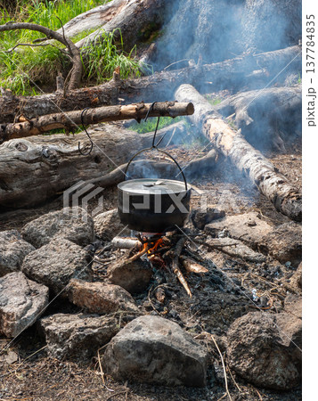 Smoke rises from a crackling campfire Smoke rises from a crackling campfire 137784835