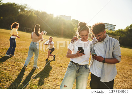 Laughing, having fun. Young friends are on the field Laughing, having fun. Young friends are on the field 137784963