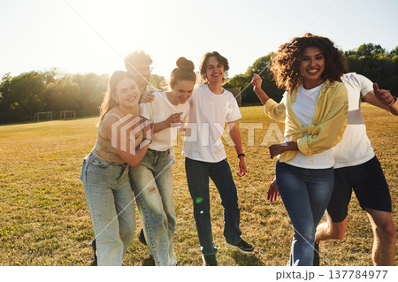 Going crazy, having fun. Young friends are on the field Going crazy, having fun. Young friends are on the field 137784977