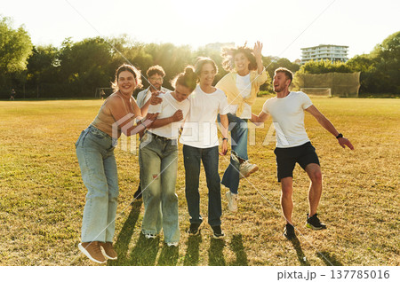 Wellbeing conception. Young friends are having fun on the field Wellbeing conception. Young friends are having fun on the field 137785016