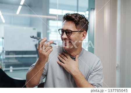 Thankful Office Scene. Individual In Office Conveys Genuine Thankfulness With Warm Smile And Gesture 137785045