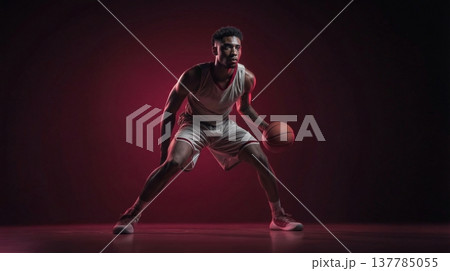 Dynamic image of strong basketball player under cinematic red lighting 137785055