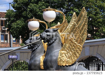 Russia, Petersburg, June 29, 2019. Winged lions on the Bank Bridge. Griffins on the bank of the bridge over the Fontanka River, according to legend, protect the golden treasures, Russia, Petersburg, June 29, 2019. Winged lions on the Bank Bridge. Griffins on the bank of the bridge over the Fontanka River, according to legend, protect the golden treasures, 137785623