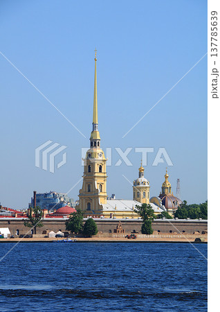 Russia, St. Petersburg, July 8, 2019, Peter and Paul Fortress. In the photo, the Peter and Paul Fortress and tourists on the beach at the dog sculpture festival, Russia, St. Petersburg, July 8, 2019, Peter and Paul Fortress. In the photo, the Peter and Paul Fortress and tourists on the beach at the dog sculpture festival, 137785639