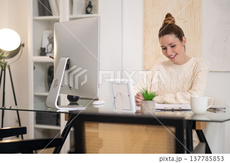 Young woman working from home and looking busy Young woman working from home and looking busy 137785853