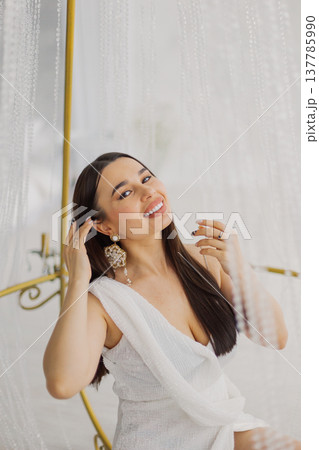 Young beautiful woman posing near gilded crystal 137785990