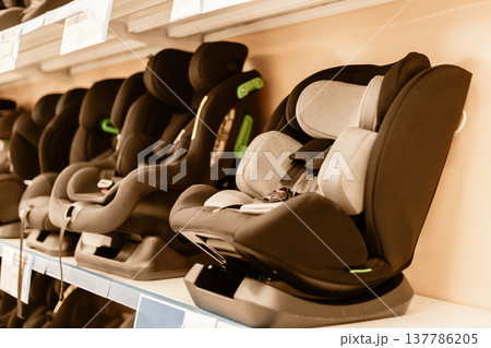 Car seats are arranged neatly on display shelves in a retail store. Parents can explore various designs and features while shopping for child safety products Car seats are arranged neatly on display shelves in a retail store. Parents can explore various designs and features while shopping for child safety products 137786205