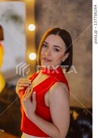 Young beautiful woman posing near mirror with 137786264