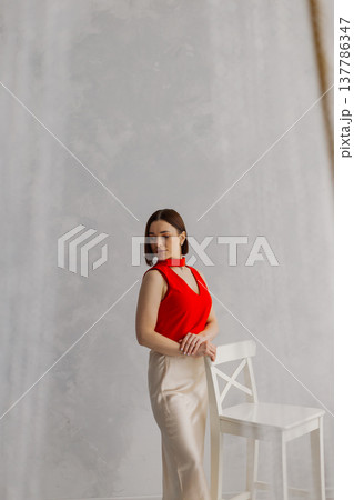 Young beautiful woman posing on wooden chair Young beautiful woman posing on wooden chair 137786347