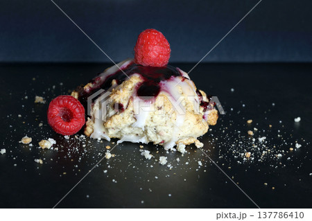 Scones with raspberry jam and lemon glaze on top 137786410