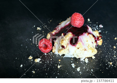 Scones with raspberry jam and lemon glaze on top 137786411