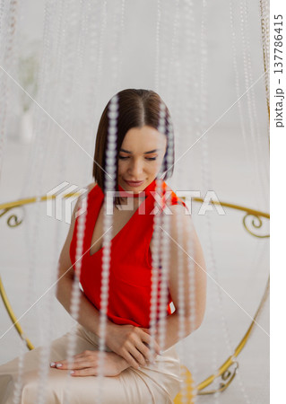 Young beautiful woman posing near gilded crystal Young beautiful woman posing near gilded crystal 137786415