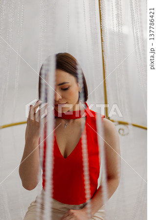Young beautiful woman posing near gilded crystal Young beautiful woman posing near gilded crystal 137786421