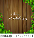 Happy St. Patrick's Day with clover leaves above wooden background 137786541