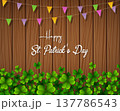 Happy St. Patrick's Day with green shamrocks above wooden background 137786543