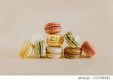 Tasty french macarons on a peach pastel background. 137786891