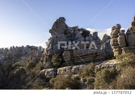 Exploring El Torcal in Spain with unique rock formations under a bright blue sky 137787052