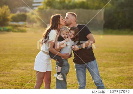 Photo of happy family with husband, wife and two kids Photo of happy family with husband, wife and two kids 137787073