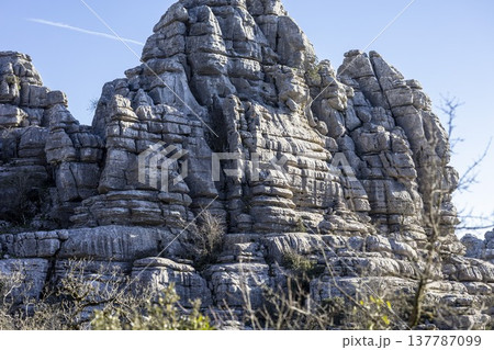 Explore unique rock formations at El Torcal in Spain during a sunny day in the winter season with clear blue skies above Explore unique rock formations at El Torcal in Spain during a sunny day in the winter season with clear blue skies above 137787099