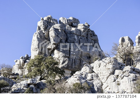 Rock formations stand tall against the blue sky at El Torcal in Spain during a sunny day 137787104