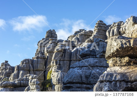 Visitors explore the unique rock formations of El Torcal in Spain during a sunny day 137787108