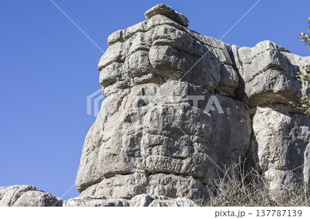 Unique rock formation located in El Torcal, Spain near the hiking trails with clear blue sky above 137787139