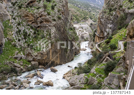 Explore Caminito del Rey in Spain with rocky cliffs, flowing river, and walking paths along the gorge Explore Caminito del Rey in Spain with rocky cliffs, flowing river, and walking paths along the gorge 137787143