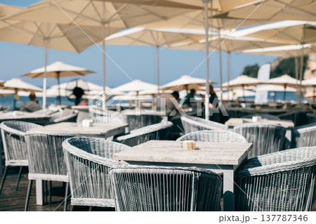 Beach cafe in a summer sunny day near the old town of Budva, Montenegro. Beach cafe in a summer sunny day near the old town of Budva, Montenegro. 137787346