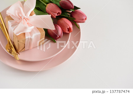 Easter Table Setting with Gift Box, Decorated Eggs and Tulips. Festive Spring Lifestyle 137787474