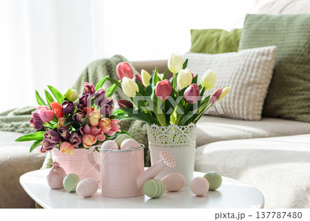 Easter Table with Tulip Bouquets, Eggs and Festive Decor. Cozy Spring Arrangement 137787480