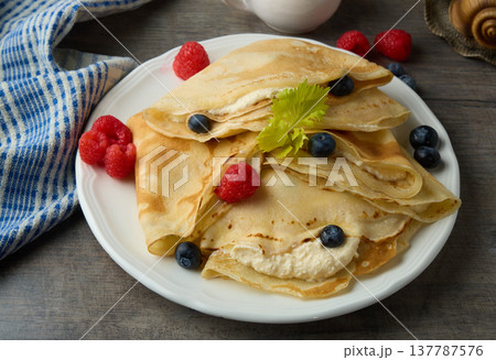 Sweet Crepes with Cream and Fresh Berries 137787576