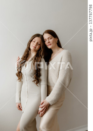 Portrait Of Mother And Teenage Girl With Confident Expressions And Coordinated Clothing Portrait Of Mother And Teenage Girl With Confident Expressions And Coordinated Clothing 137787798