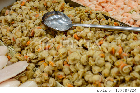 Seafood market tray of cooked clams with serving spoon Seafood market tray of cooked clams with serving spoon 137787824