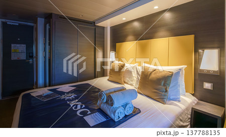 Tokyo, Japan - Oct 2 2024, panoramic view of interior of living cabin with four beds, illuminated by bedside lamps and overhead light, without people, on the MSC Bellissima cruise ship, Tokyo, Japan Tokyo, Japan - Oct 2 2024, panoramic view of interior of living cabin with four beds, illuminated by bedside lamps and overhead light, without people, on the MSC Bellissima cruise ship, Tokyo, Japan 137788135