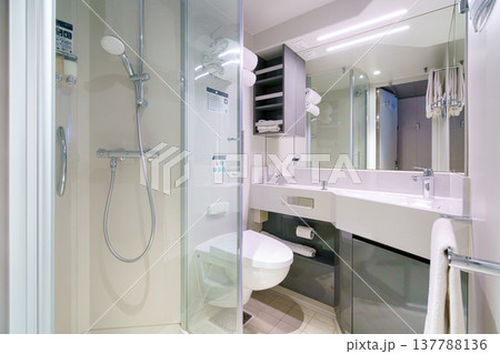 Tokyo, Japan - Oct 2 2024, panoramic view of the bathroom with shower, sink and toilet, brightly illuminated by overhead light, without people, on the MSC Bellissima cruise ship, Tokyo, Japan Tokyo, Japan - Oct 2 2024, panoramic view of the bathroom with shower, sink and toilet, brightly illuminated by overhead light, without people, on the MSC Bellissima cruise ship, Tokyo, Japan 137788136