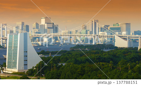 Tokyo, Japan - Oct 2 2024, Panoramic view of the Odaiba Island Park, with the Rainbow Bridge in the background against the backdrop of the city, at evening, Tokyo, Japan Tokyo, Japan - Oct 2 2024, Panoramic view of the Odaiba Island Park, with the Rainbow Bridge in the background against the backdrop of the city, at evening, Tokyo, Japan 137788151