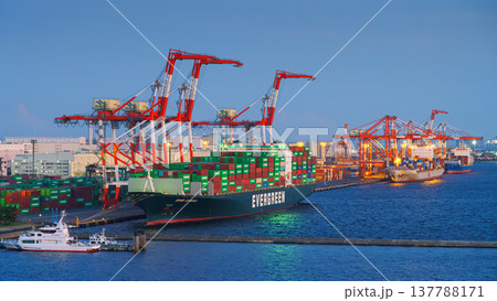 Tokyo, Japan - Oct 2 2024, panoramic view of docks with cranes and a moored giant Evergreen cargo ship loaded with containers, at daytime, Tokyo, Japan Tokyo, Japan - Oct 2 2024, panoramic view of docks with cranes and a moored giant Evergreen cargo ship loaded with containers, at daytime, Tokyo, Japan 137788171