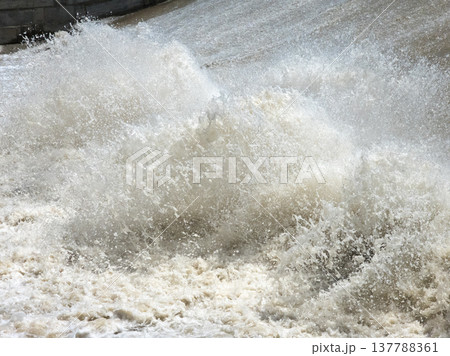 Dynamic water splashing near concrete structure during daytime Dynamic water splashing near concrete structure during daytime 137788361