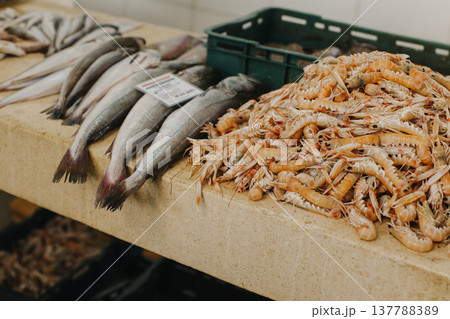 Fresh fish and shrimps on ice at the traditional fish market. 137788389