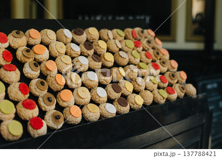 Colorful Choux cakes in a Parisian cafe. French pastries. 137788421