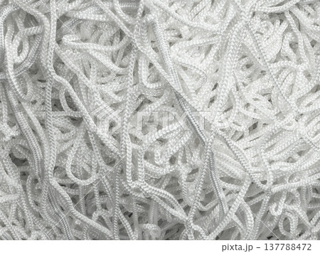Tangled off-white cords and ropes in industrial setting Tangled off-white cords and ropes in industrial setting 137788472
