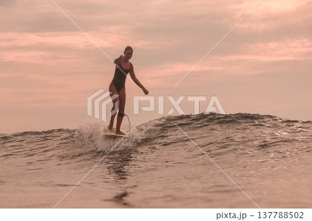 Gracious Lady Maintains Perfect Balance On Her Longboard Beneath Setting Sun Gracious Lady Maintains Perfect Balance On Her Longboard Beneath Setting Sun 137788502