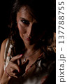 Enigmatic lady communicates softly in cozy setting, An intriguing female figure silently shares concealed messages within softly illuminated and intimate environment 137788755