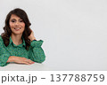 Happy professional portrait, Confident woman with friendly smile, Elegant brunette woman in green blouse exhibiting confidence and approachability in studio setting 137788759